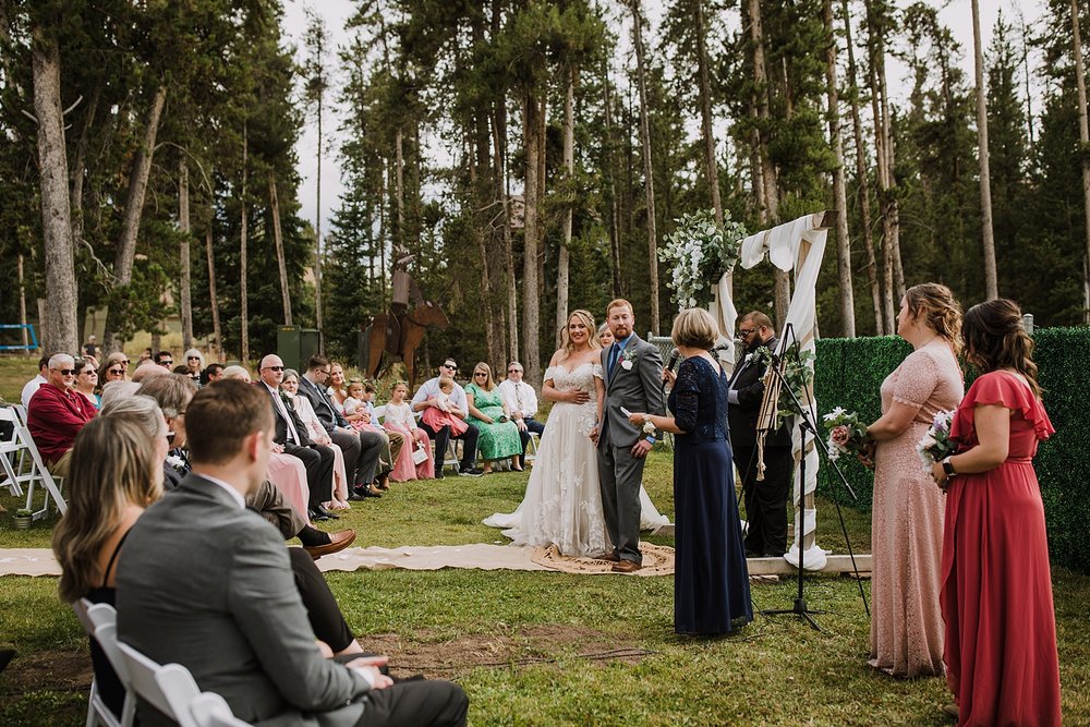 bride and groom standing together during ceremony, breckenridge colorado fall wedding, carter park pavilion fall wedding, intimate wedding reception at carter park pavilion in breckenridge