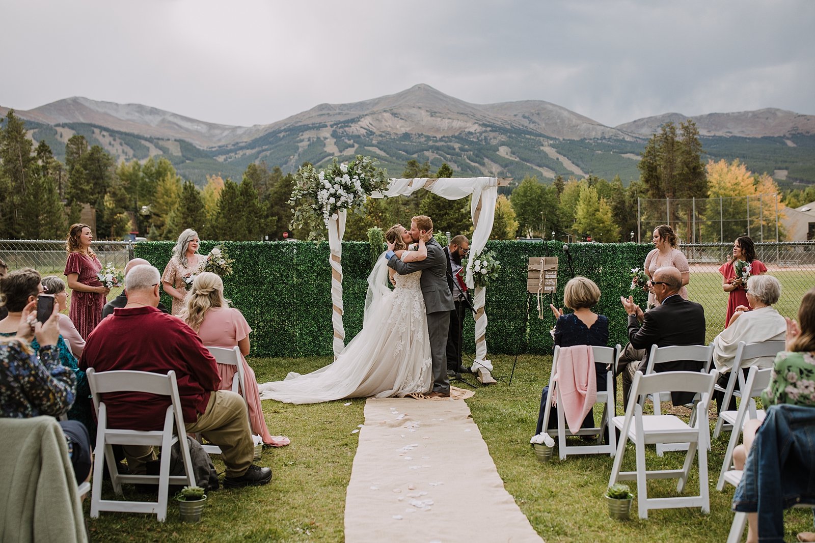 bride and groom kissing, evening ceremony at carter park, summer wedding in breckenridge colorado, park wedding venue in breckenridge colorado, summit county forest wedding