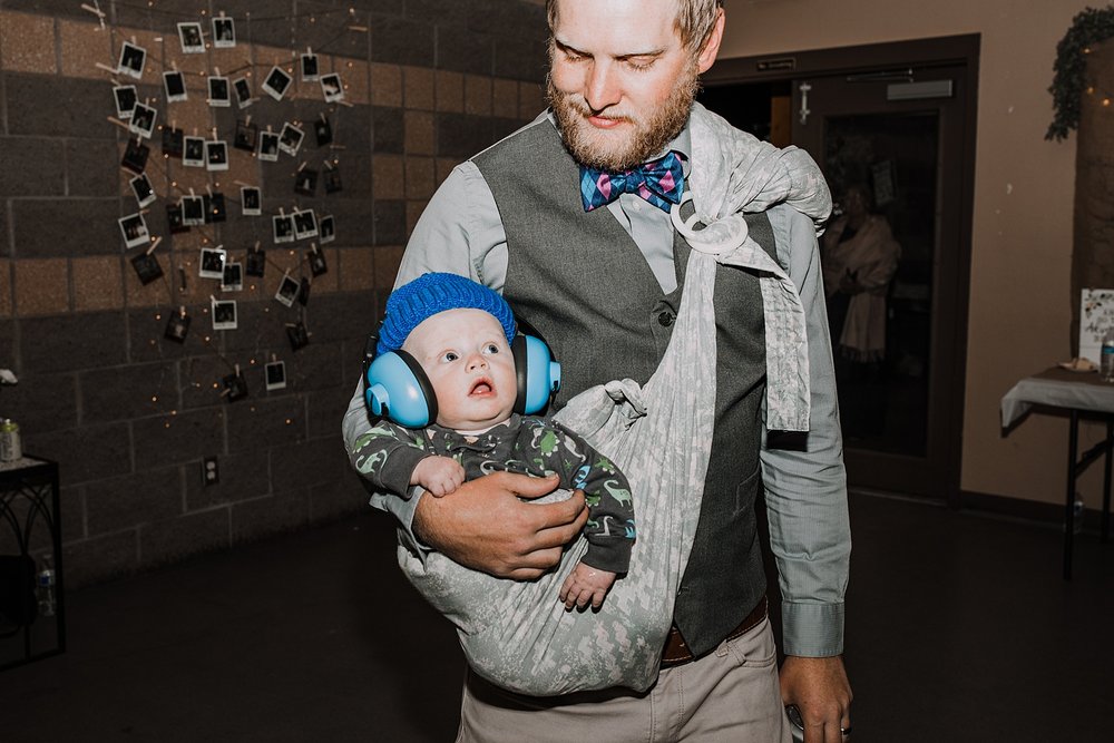 baby with headphones during wedding reception, wedding guests dancing, carter park pavilion dance floor, carter park pavilion dance reception, breckenridge historic district wedding reception