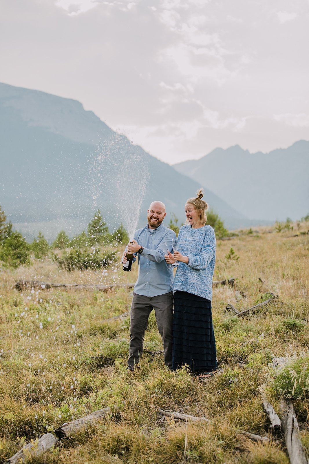 couple celebrating with a champagne toast, silverthorne colorado wedding photographer, silverthorne pavilion wedding photographer, summit county wedding photographer, lily pad lake engagement