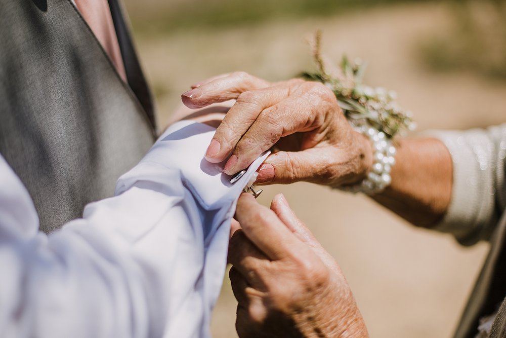 groom putting on cufflinks, groom getting ready, groom details, mountain groom, grooms attire, silverthorne colorado wedding, silverthorne colorado wedding photographer