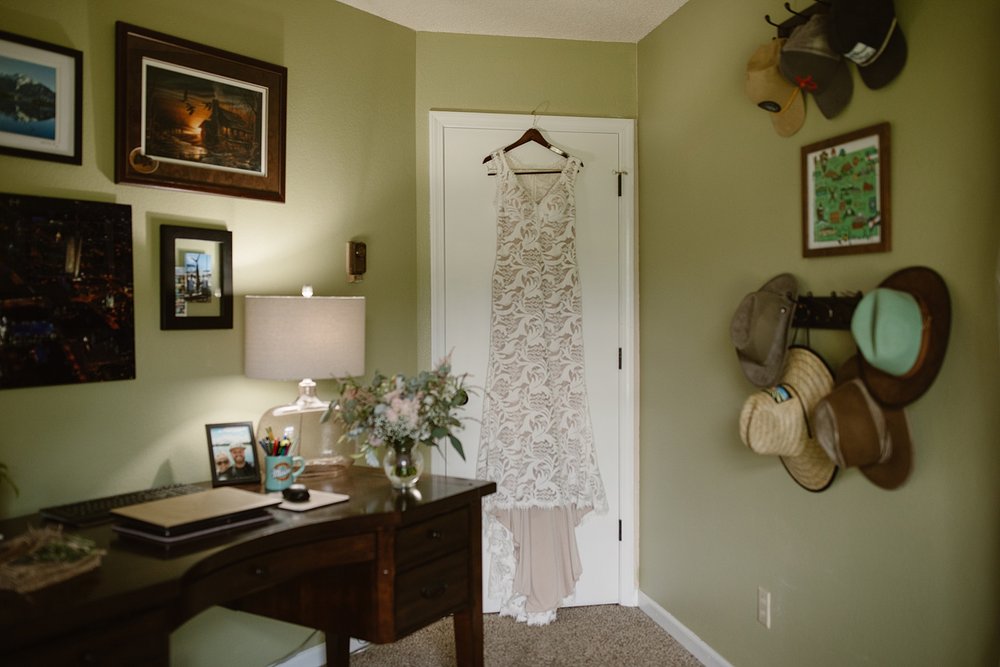 wedding dress hanging in bride's dressing room, wedding getting ready details, wedding dress details, silverthorne colorado wedding, silverthorne colorado wedding photographer