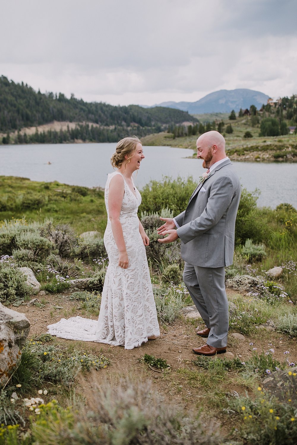 bride and groom for first look at dillon lake, groom in gray suit, dillon lake reservoir wedding, summit cove wedding, keystone colorado wedding, keystone colorado wedding photographer