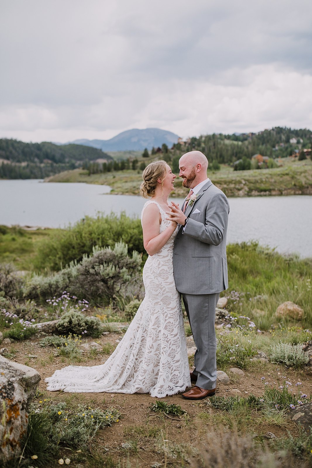 bride and groom for first look at dillon lake, groom in gray suit, dillon lake reservoir wedding, summit cove wedding, keystone colorado wedding, keystone colorado wedding photographer