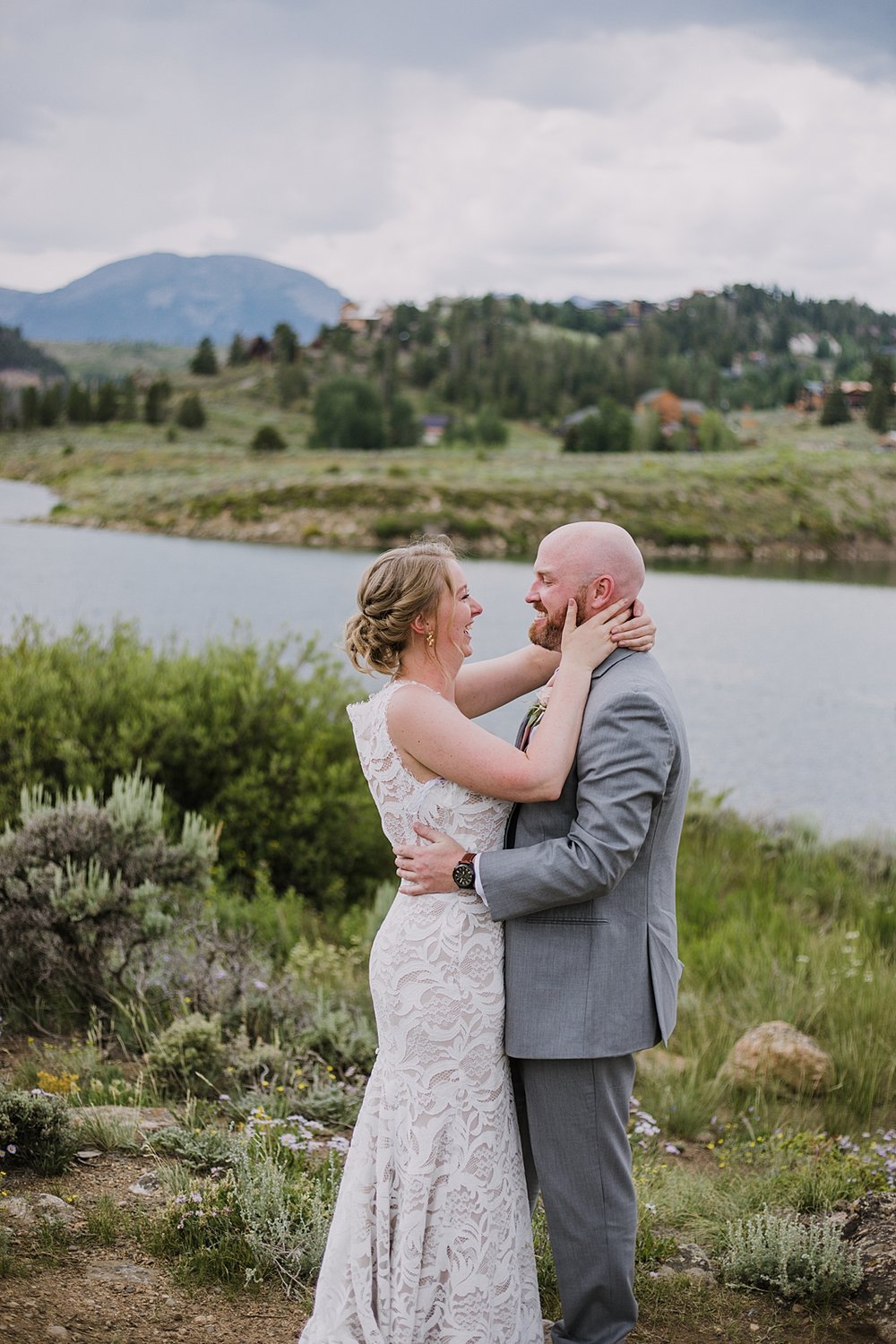 bride holding grooms face in her hands, bride wearing bhldn, dillon lake reservoir wedding, summit cove wedding, keystone colorado wedding, keystone colorado wedding photographer, colter bay wedding