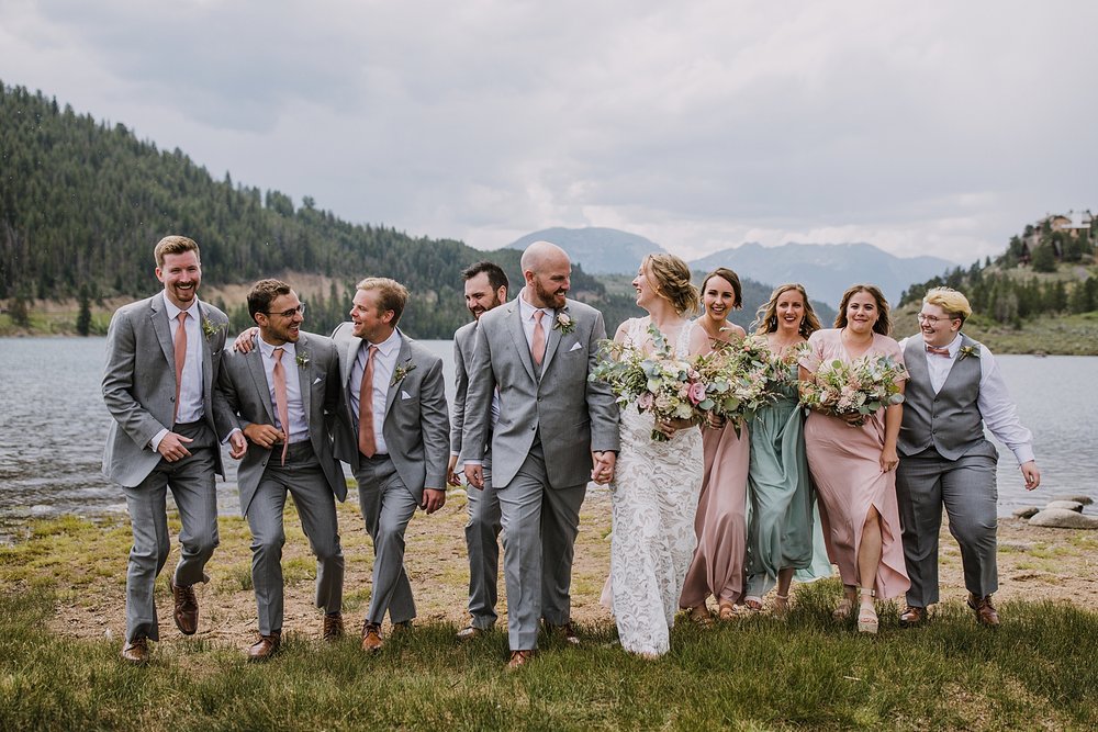 colorado bridal party walking together on lake shore, lake shore group photo location, summit county wedding photographer, snake inlet wedding, snake inlet fishing, summit county colorado wedding