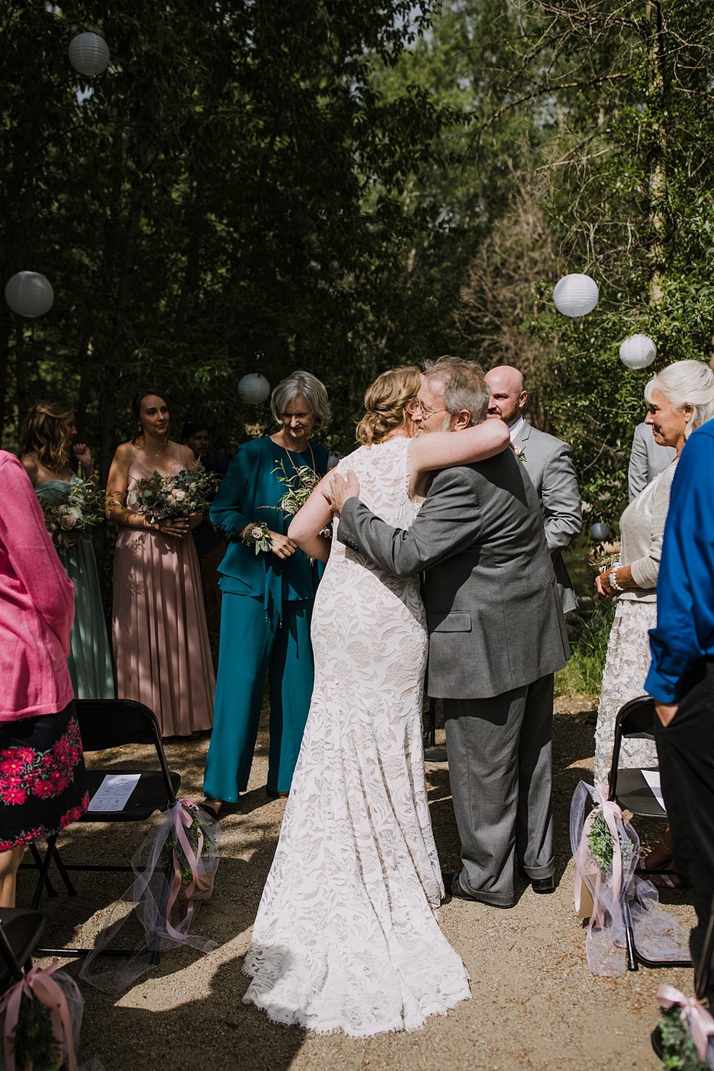 bride hugging her father, father giving away the bride, silverthorne pavilion wedding ceremony, silverthorne colorado mountain wedding, gore range wedding, silverthorne pavilion wedding photographer