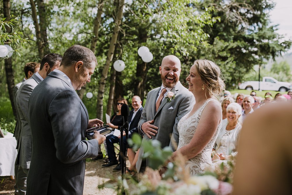 officiant talking during mountain ceremony, jackson hole wedding, grand teton national park wedding, jackson lake lodge wedding, wyoming wedding photographer, jackson hole wedding photographer