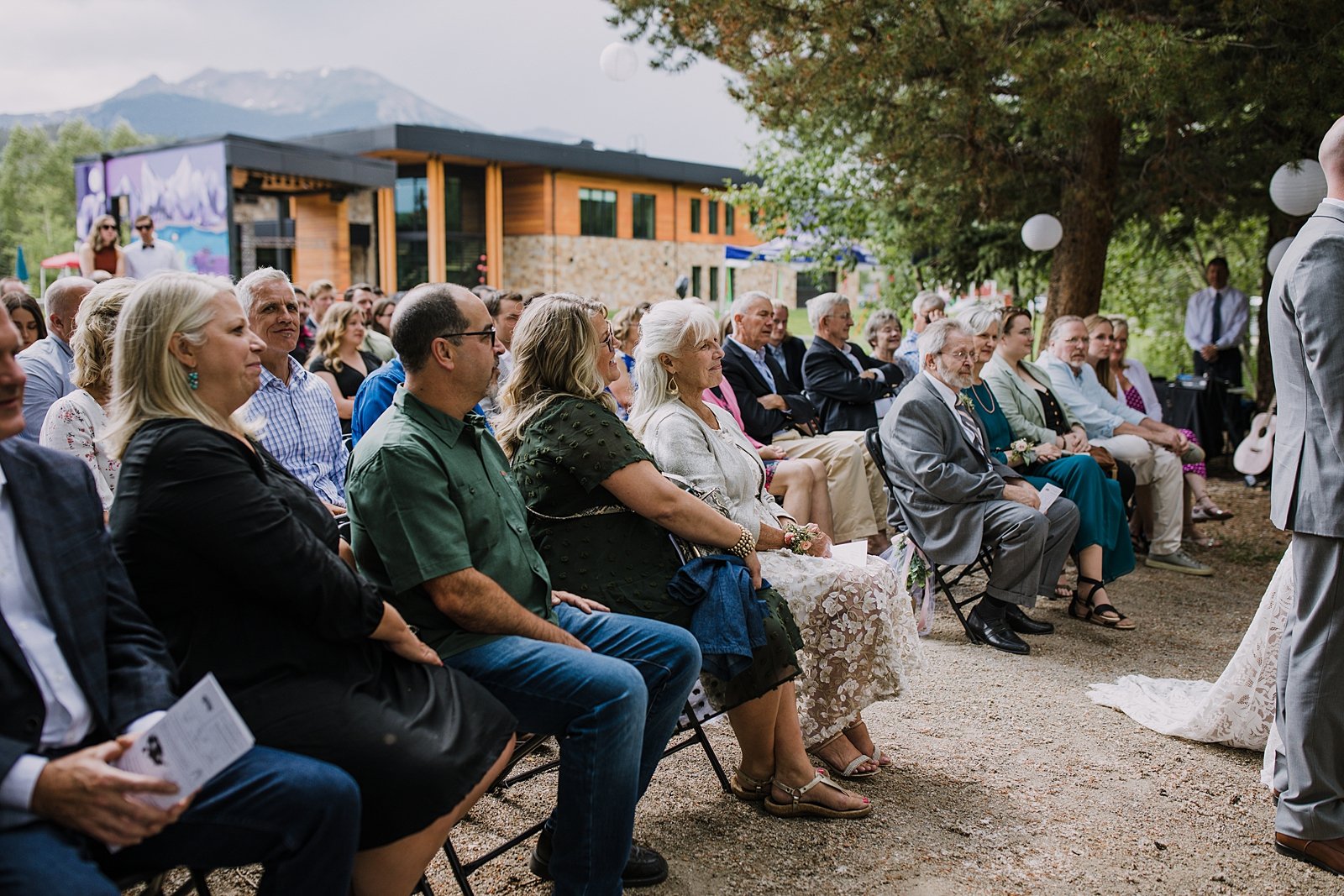 guests watching bride and groom, silverthorne pavilion wedding ceremony, silverthorne colorado mountain wedding, gore range wedding, silverthorne pavilion wedding photographer