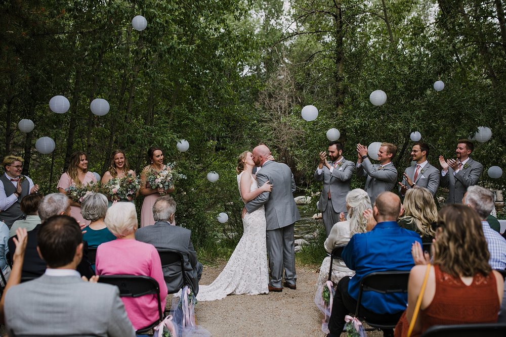 bride and groom kissing, first kiss as husband and wife, silverthorne pavilion wedding ceremony, silverthorne colorado bride, mountain couple, mountain bride, mountain groom