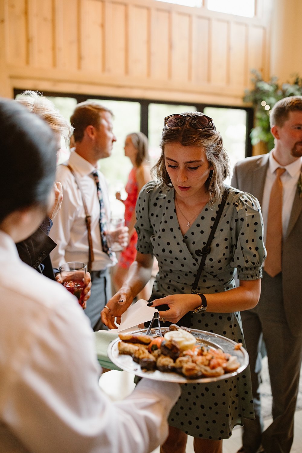 wedding guests enjoying appetizers and tapas, summit county wedding catering, silverthorne pavilion wedding bar, silverthorne colorado cocktail bar, wedding cocktails, mountain wedding bar