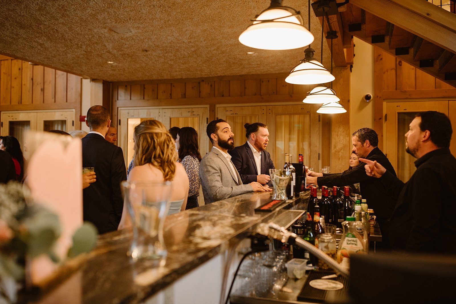 wedding guests ordering drinks from bar, summit county wedding bar, silverthorne pavilion wedding bar, silverthorne colorado cocktail bar, wedding cocktails, mountain wedding bar