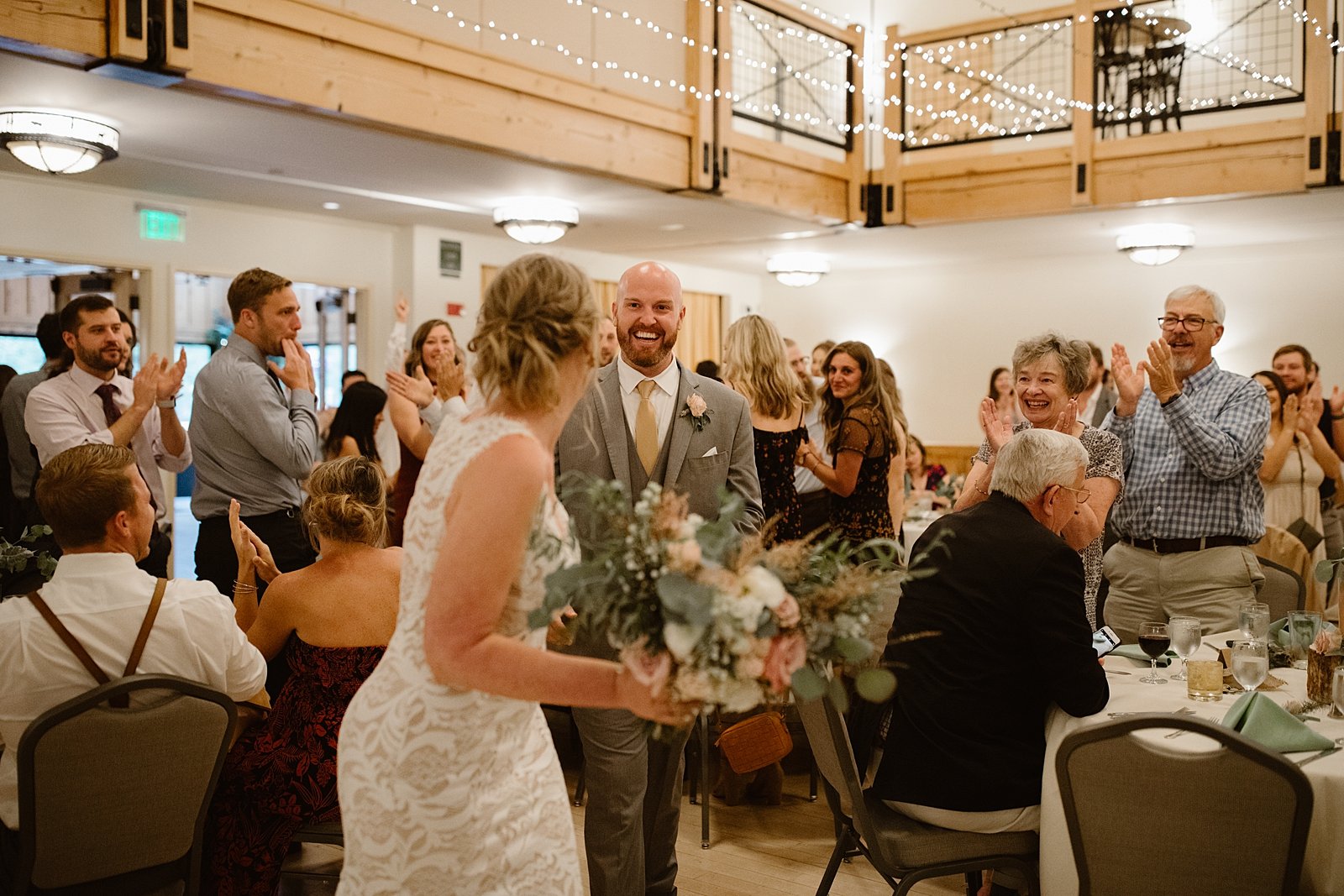 bride and groom grand entrance, silverthorne pavilion wedding dinner, silverthorne pavilion wedding reception, summit county indoor reception space, dillon colorado wedding reception