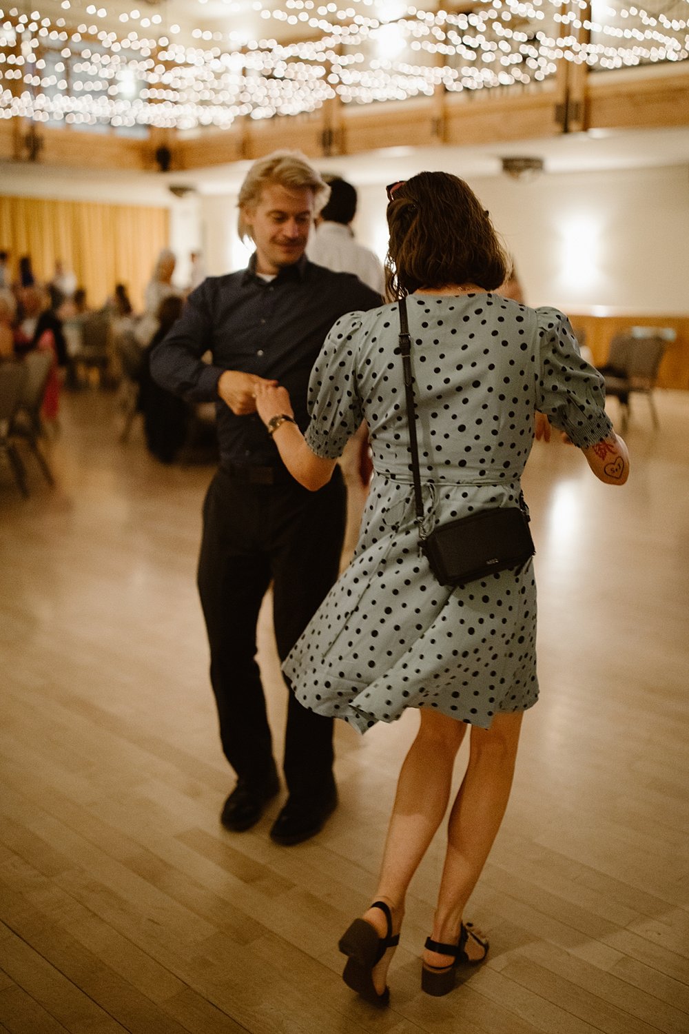 wedding guests dancing, wedding dancing under string lights, silverthorne pavilion dance floor, summit county wedding dance floor, silverthorne colorado wedding photographer, silverthorne wedding DJ