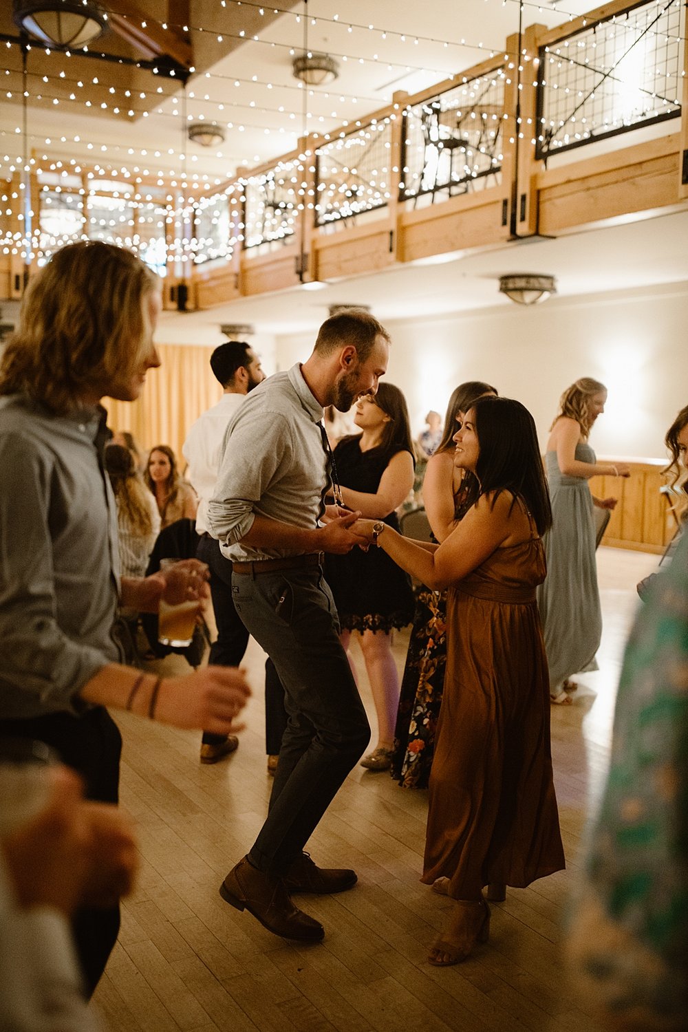 wedding guests dancing, wedding dancing under string lights, silverthorne pavilion dance floor, summit county wedding dance floor, silverthorne colorado wedding photographer, silverthorne wedding DJ