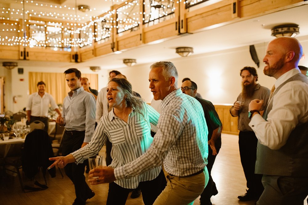 wedding guests on the dance floor, wedding reception under string lights, silverthorne pavilion dancing, dillon colorado wedding DJ, summit county wedding photographer, summit county wedding DJ