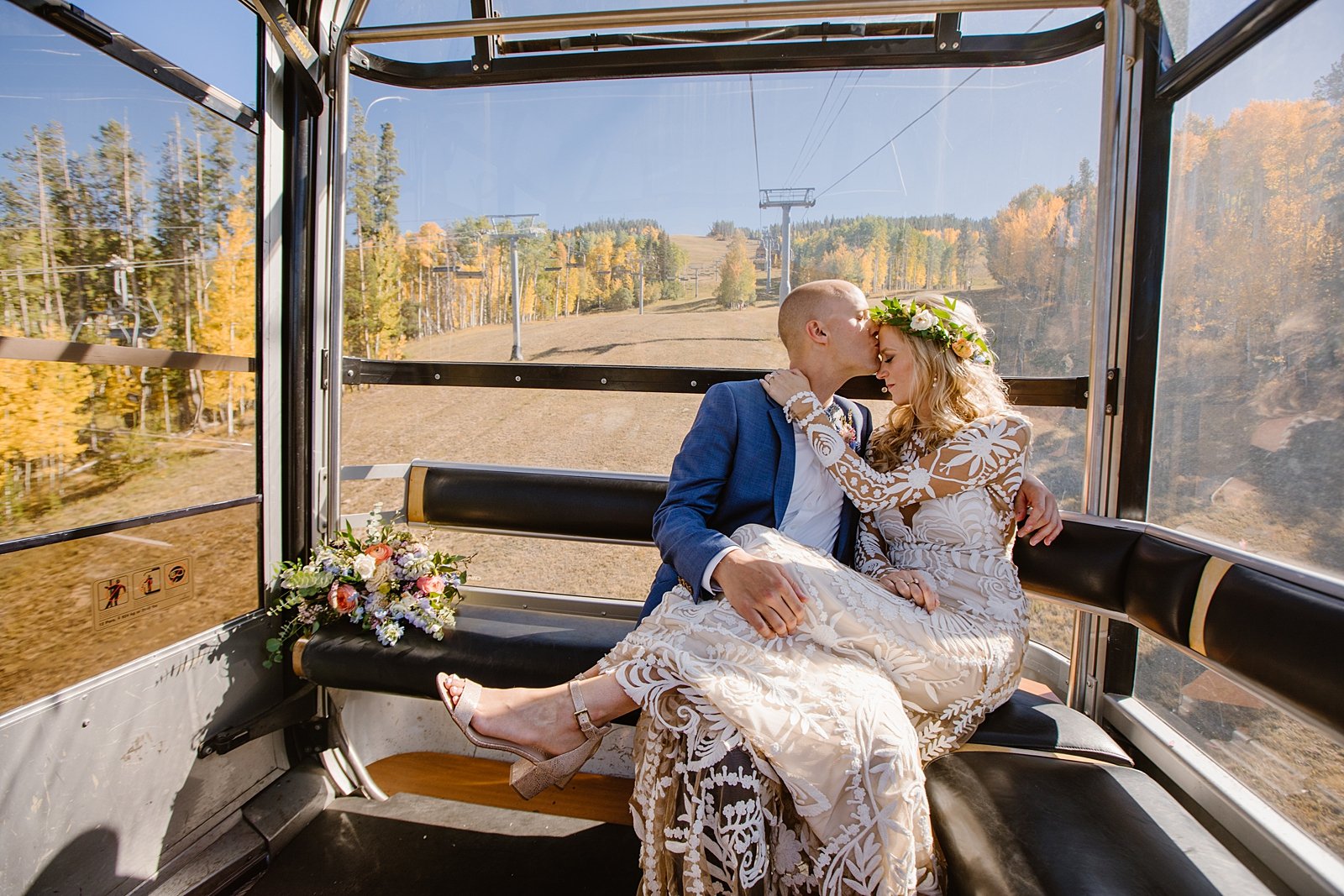 bride and groom riding in the gondola, breckenridge resort wedding, breckenridge gondola ride, ski gondola, wedding in a gondola, bridal portraits at a ski resort, lace wedding dress