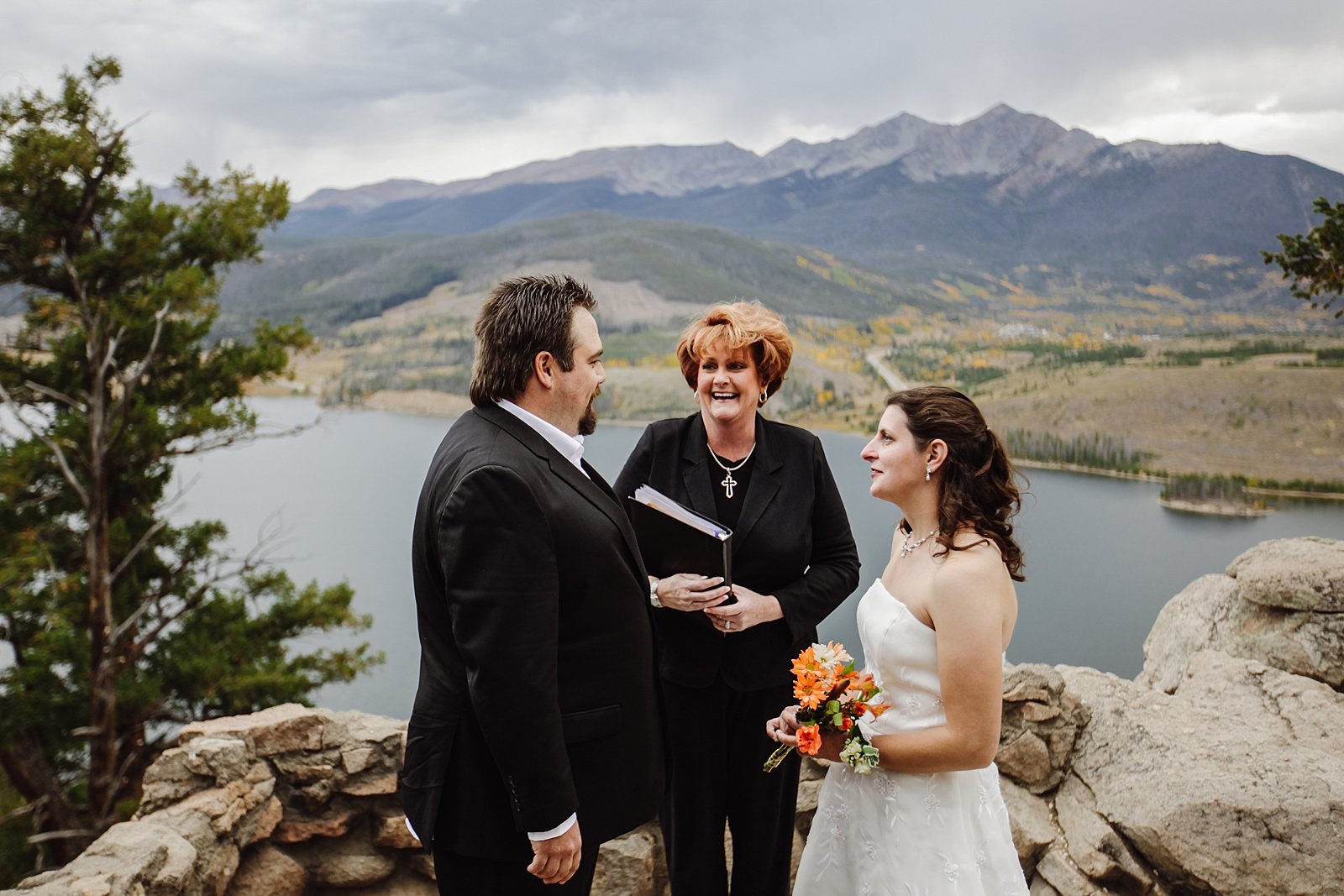 couple and officiant laughing during vows, sapphire point wedding, sapphire point elopement, sapphire point view, sapphire point wedding permit, dillon reservoir elopement, dillon reservoir wedding