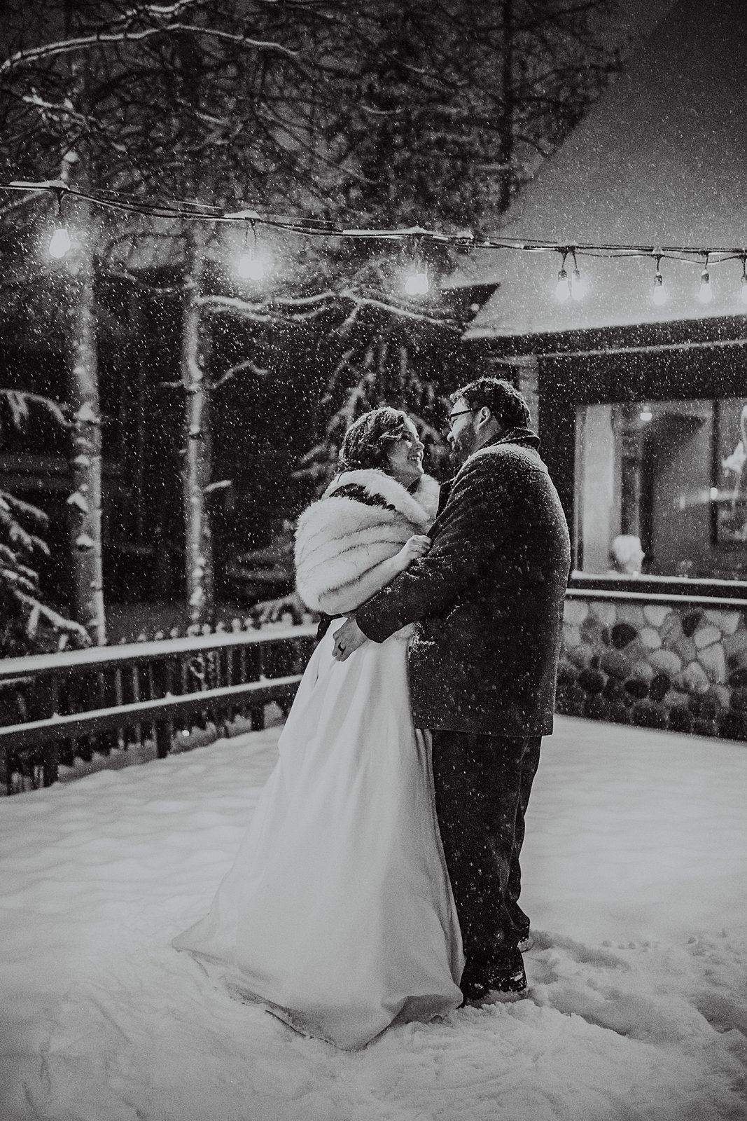 bride and groom dancing in the snow, winter elopement in breckenridge, snowy elopement first dance, fur bridal shawl, ember wedding reception, maggie pond elopement, breckenridge winter wedding