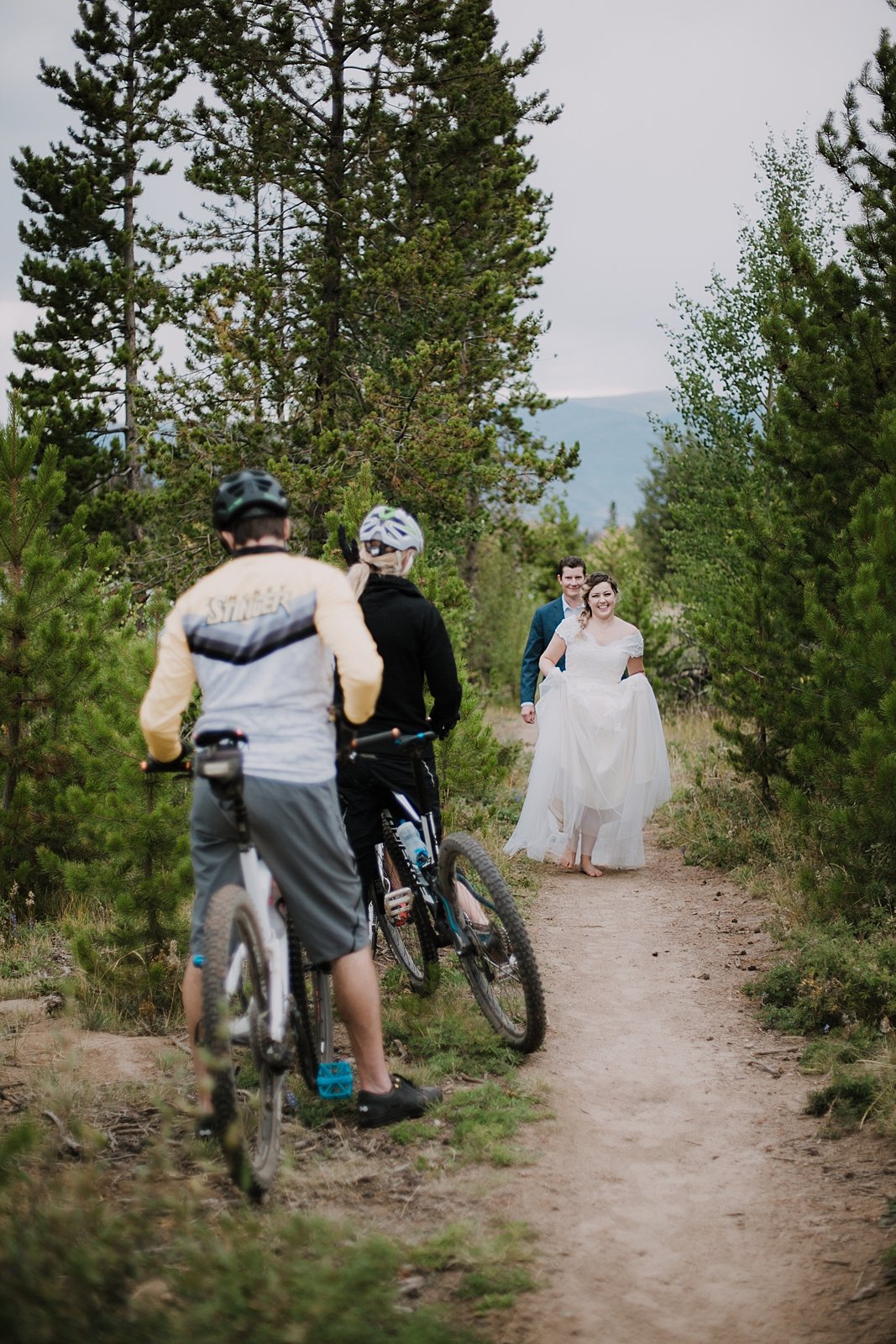 bride and groom hiking barefoot, barefoot bride, mountain biking elopement, breckenridge hiking elopement, sapphire point elopement, colorado trail elopement, carter park pavilion wedding