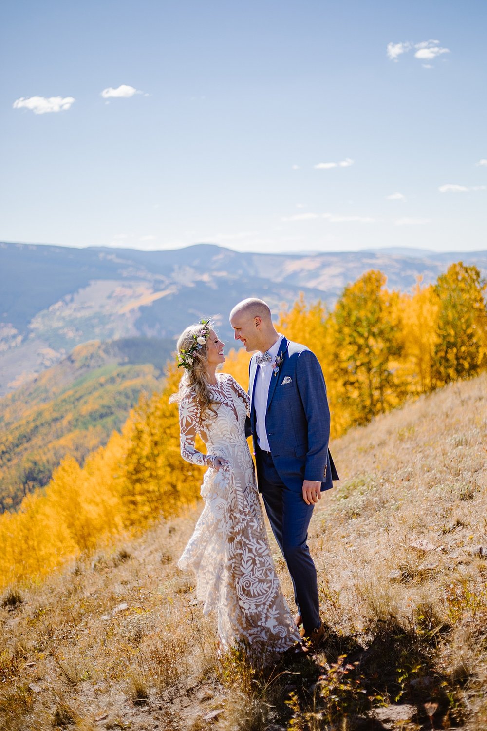 bride and groom in colorful aspen trees, bridal floral crown, grooms floral bowtie, breckenridge ski resort wedding, breckenridge fall wedding, breckenridge mountainside elopement, colorado elopement