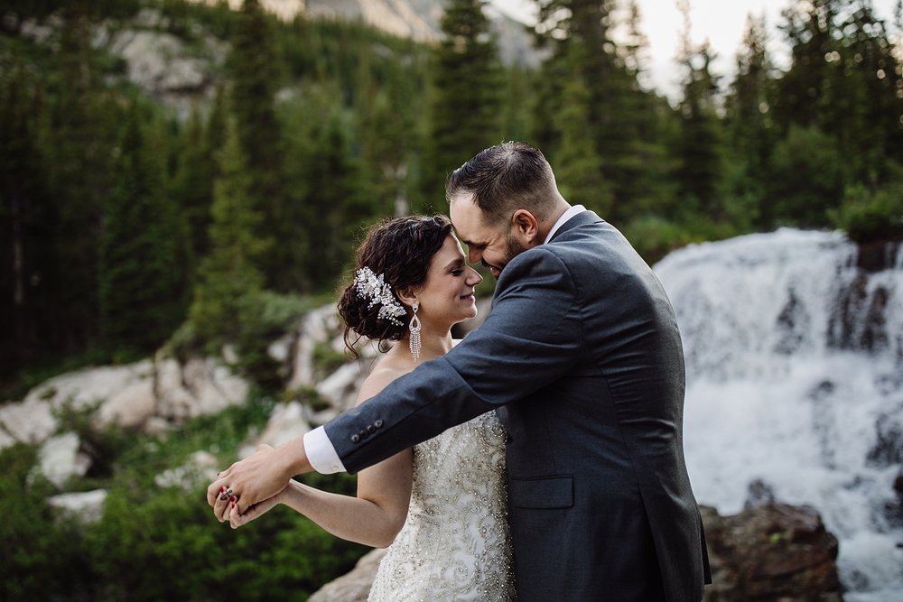 couple dancing in front of a waterfall, breckenridge waterfall, blue lakes elopement, blue lakes hike, mount quandary elopement, crystal lakes elopement, mohawk lakes elopement, blue river wedding