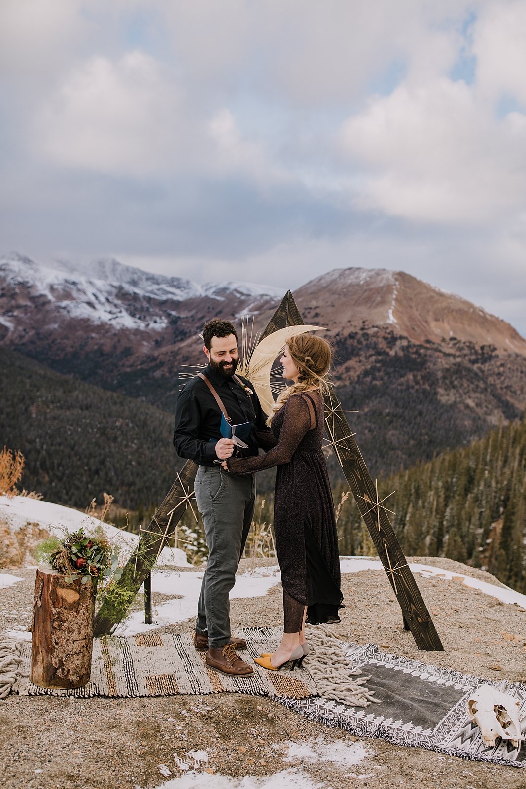 groom laughing while reading his vows, summit county elopement, summit county wedding, arapaho basin elopement, arapaho basin wedding, loveland pass elopement, loveland pass ceremony site, black dress
