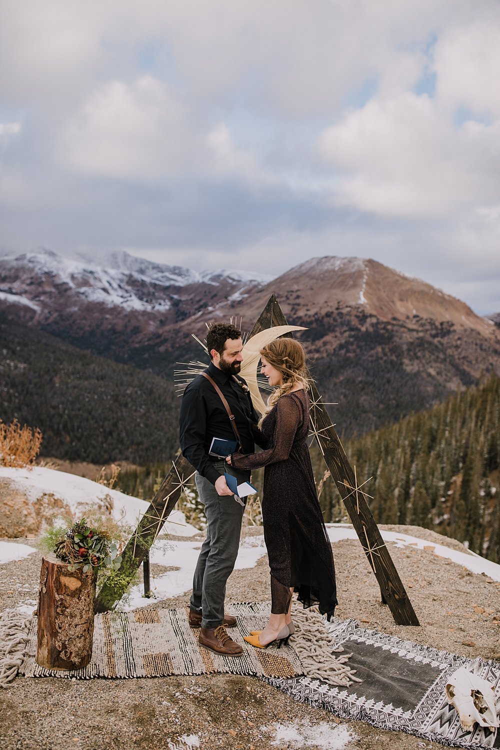 bride and groom reading vows during ceremony, loveland pass wedding, fall mountain elopement, fall mountain wedding, colorado fall wedding, colorado fall elopement, black wedding attire, black dress