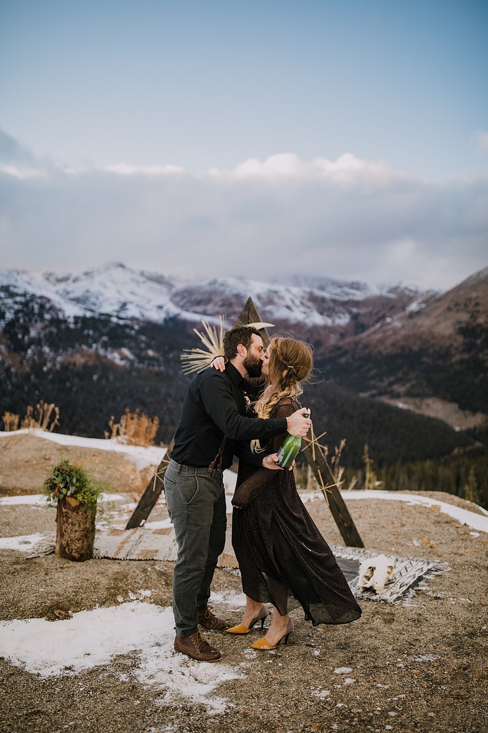 couple kissing post champagne pop, mountain top elopement, mountain top ceremony, high alpine mountain pass elopement, high alpine mountain pass wedding ceremony, mountain peak ceremony