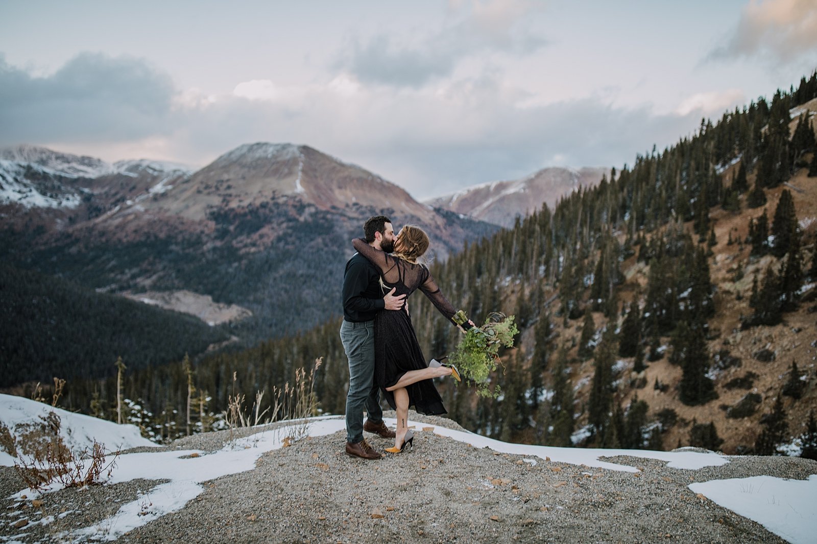 bride and groom kissing at sunset, snow capped mountain elopement, mountain pass elopement, summit county fall elopement, high alpine elopement, moody weather elopement, loveland pass elopement