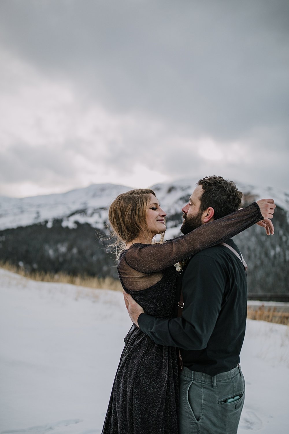 bride and groom hugging, continental divide elopement, continental divide wedding, celestial elopement, celestial wedding, lunar elopement, lunar wedding, snowy mountain peak wedding backdrop