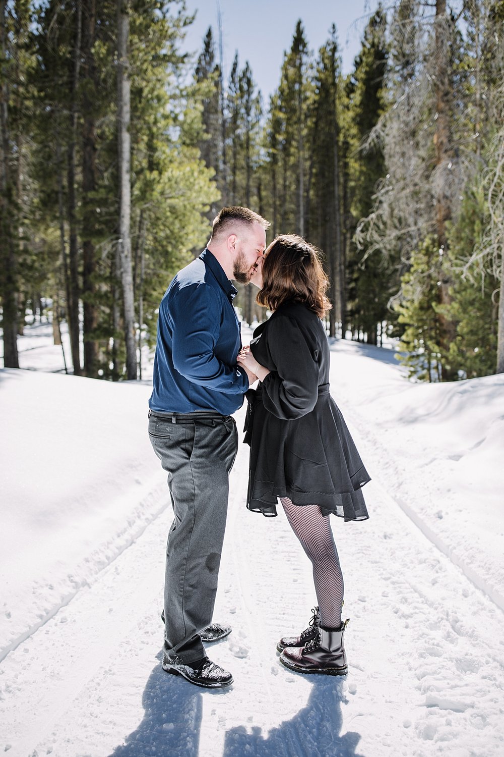 couple kissing in the snow, snowy engagement, engagements in the woods, proposal in the woods, swan river valley engagement, swan river valley winter activities, breckenridge winter activities