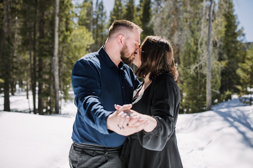couple kissing in the trees, engagement ring, ways to show off your engagement ring, engagement ring posing, georgia pass engagements, georgia pass proposal, snowmobile proposal