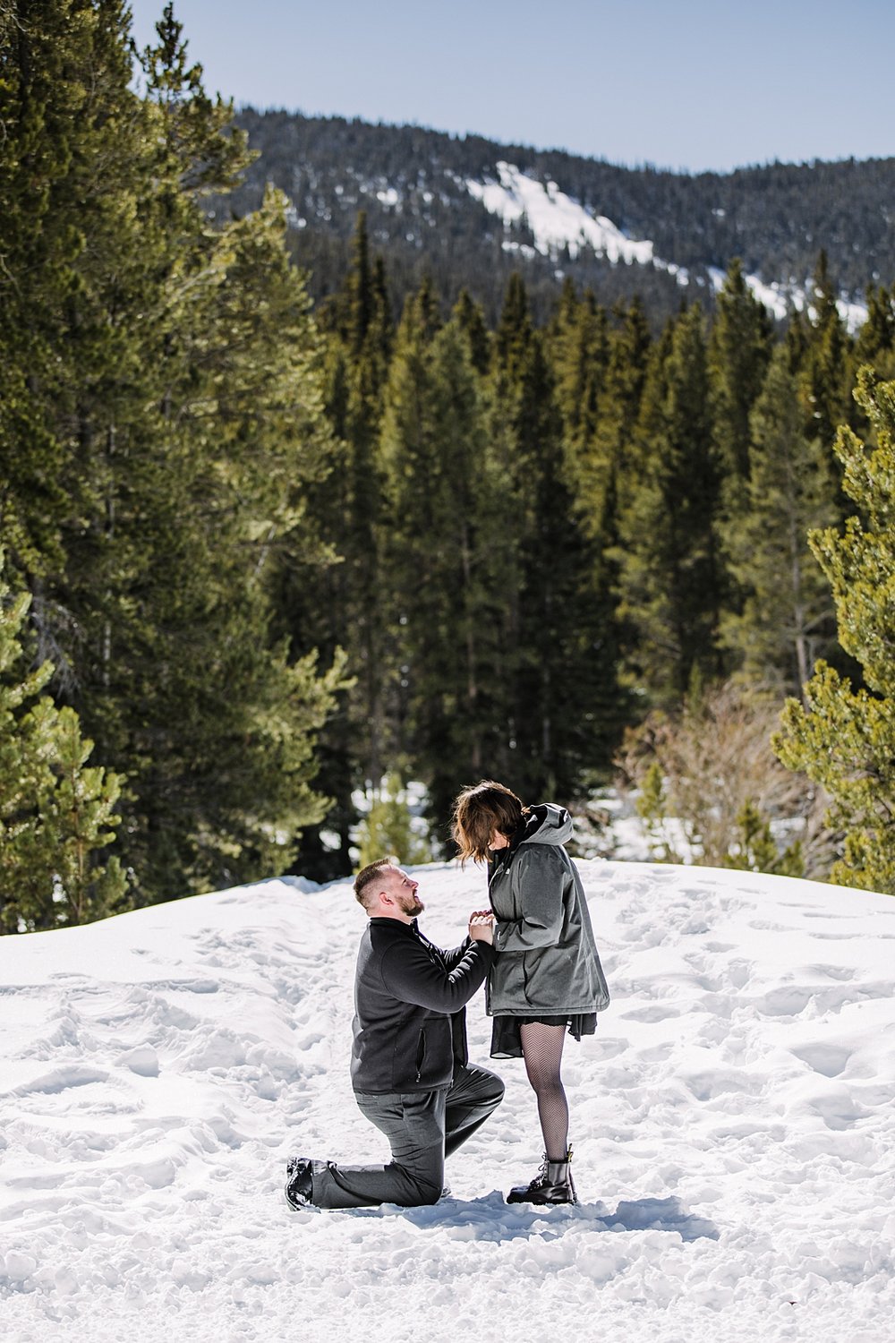 man kneeling to propose, winter proposal, mountain proposal, breckenridge proposal, horse drawn sleigh proposal, good times adventures proposal, breckenridge colorado horse sleigh ride