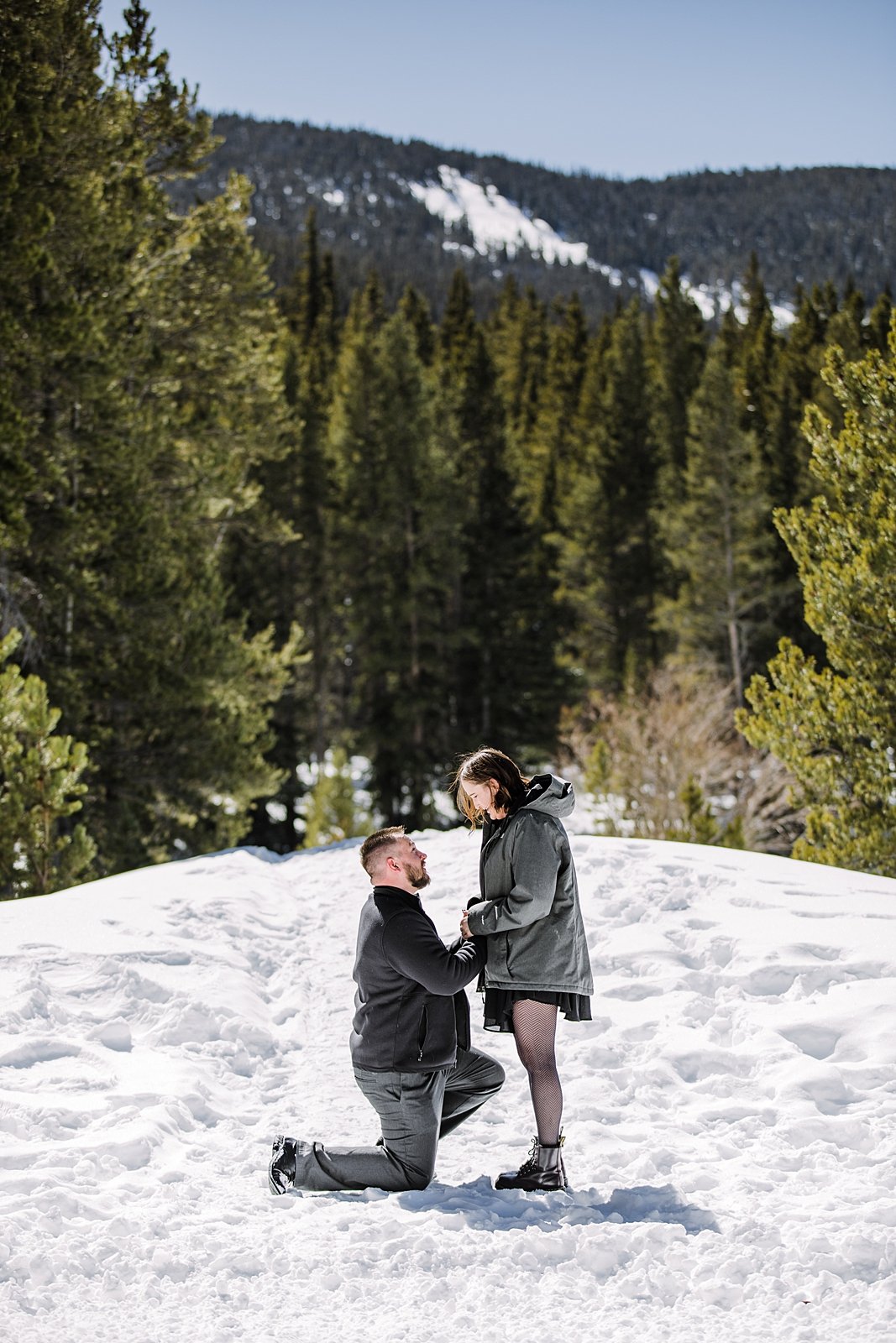man kneeling and proposing in the snow, winter engagement, breckenridge snowy engagements, breckenridge winter engagements, snowy proposal, christmas engagement, christmas proposal