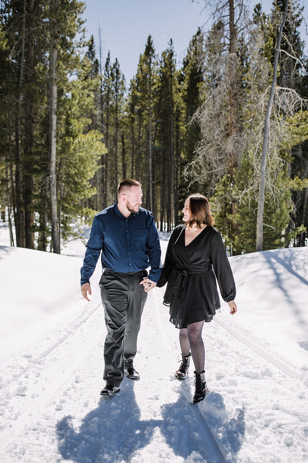 couple walking in the snow, snowy engagement, engagements in the woods, proposal in the woods, swan river valley engagement, swan river valley winter activities, breckenridge winter activities