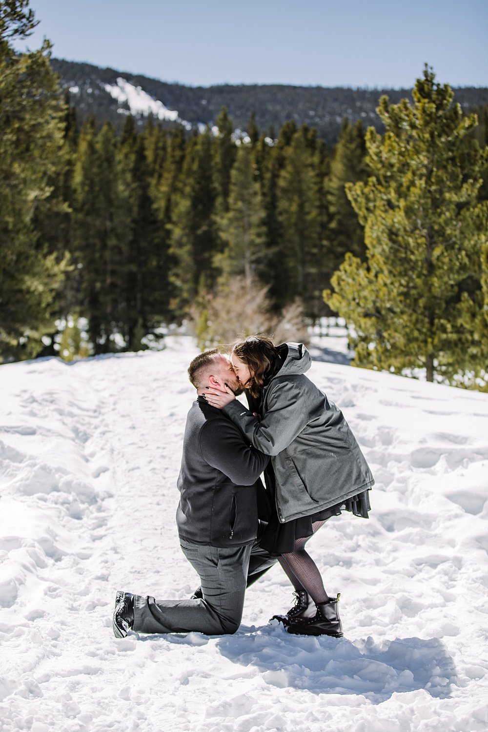 girl says yes to man's proposal, couple kissing in the snow, colorado mountain proposal, colorado winter proposal, colorado mountain engagements, colorado winter engagements, black proposal nails