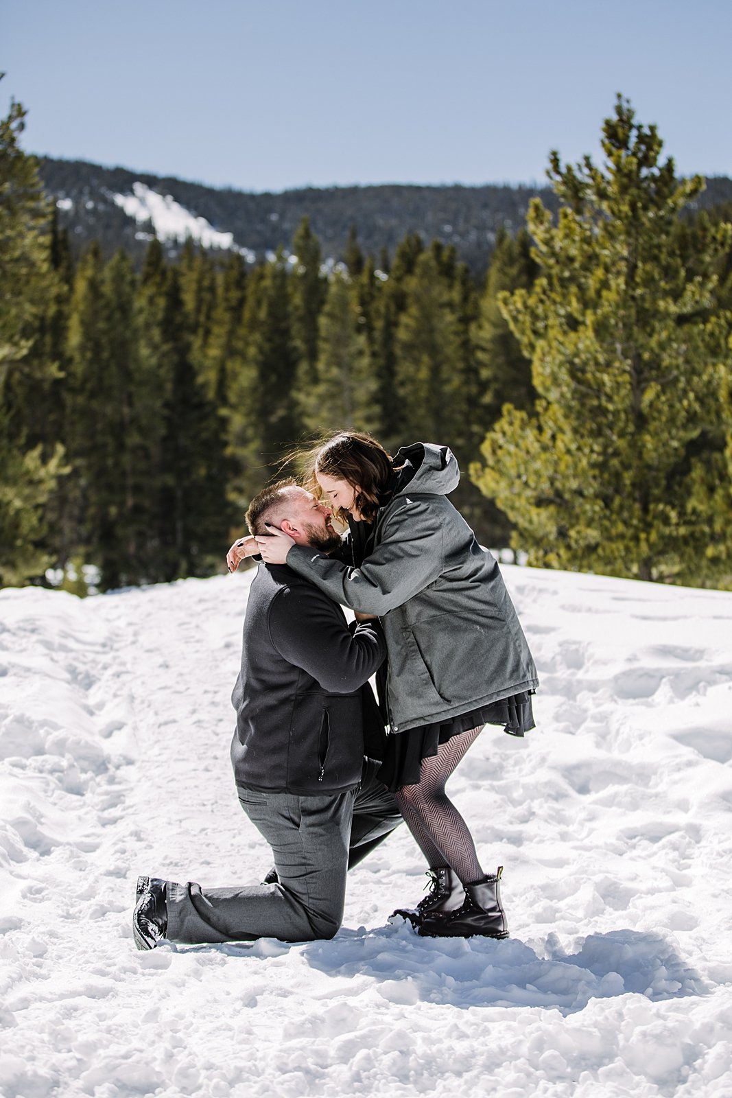 girl says yes to man's proposal, couple kissing in the snow, colorado mountain proposal, colorado winter proposal, colorado mountain engagements, colorado winter engagements, black proposal nails