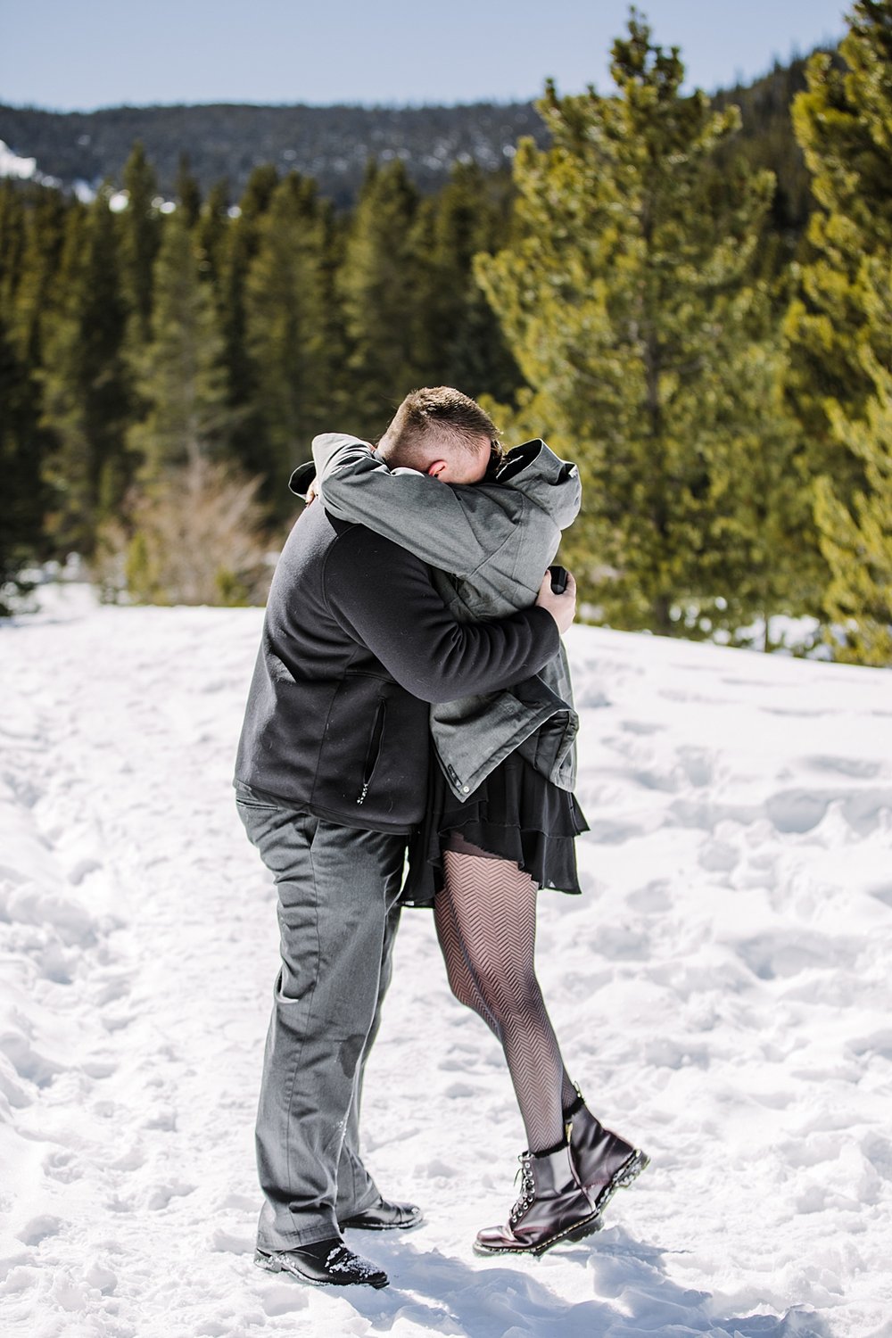 couple hugging in the snow, colorado mountain proposal, colorado winter proposal, colorado mountain engagements, colorado winter engagements, she said yes, golden horseshoe sleigh ride proposal