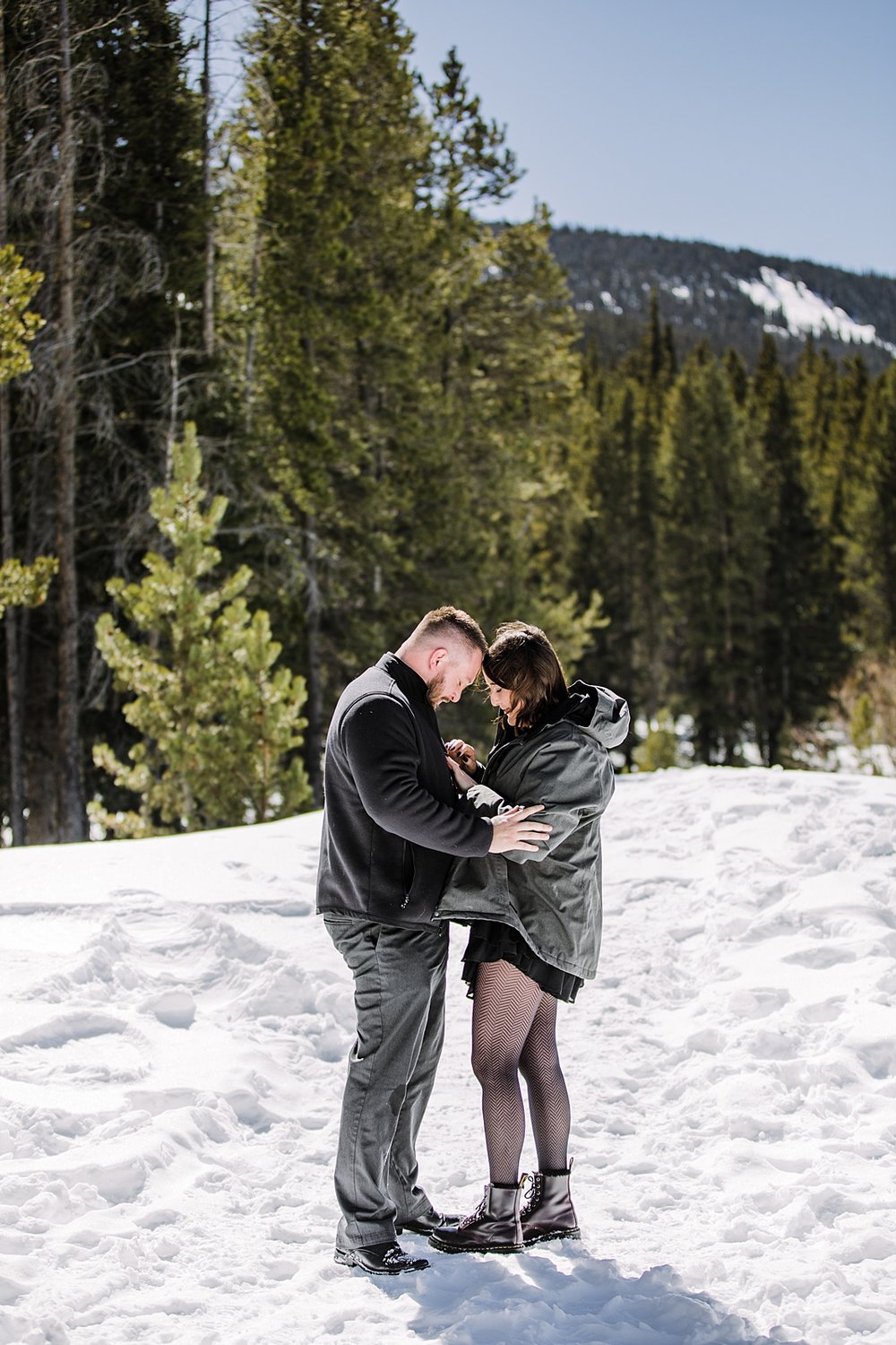 couple admiring ring after proposal, engagements in the woods, proposal in the woods, swan river valley engagement, swan river valley winter activities, colorado winter activities