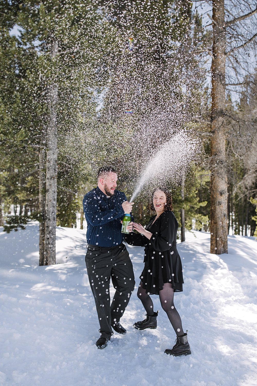 couple popping champagne, popping champagne in the woods, post proposal champagne pop, popping champagne in the mountains, proposal champagne pop, champagne pop in the national forest