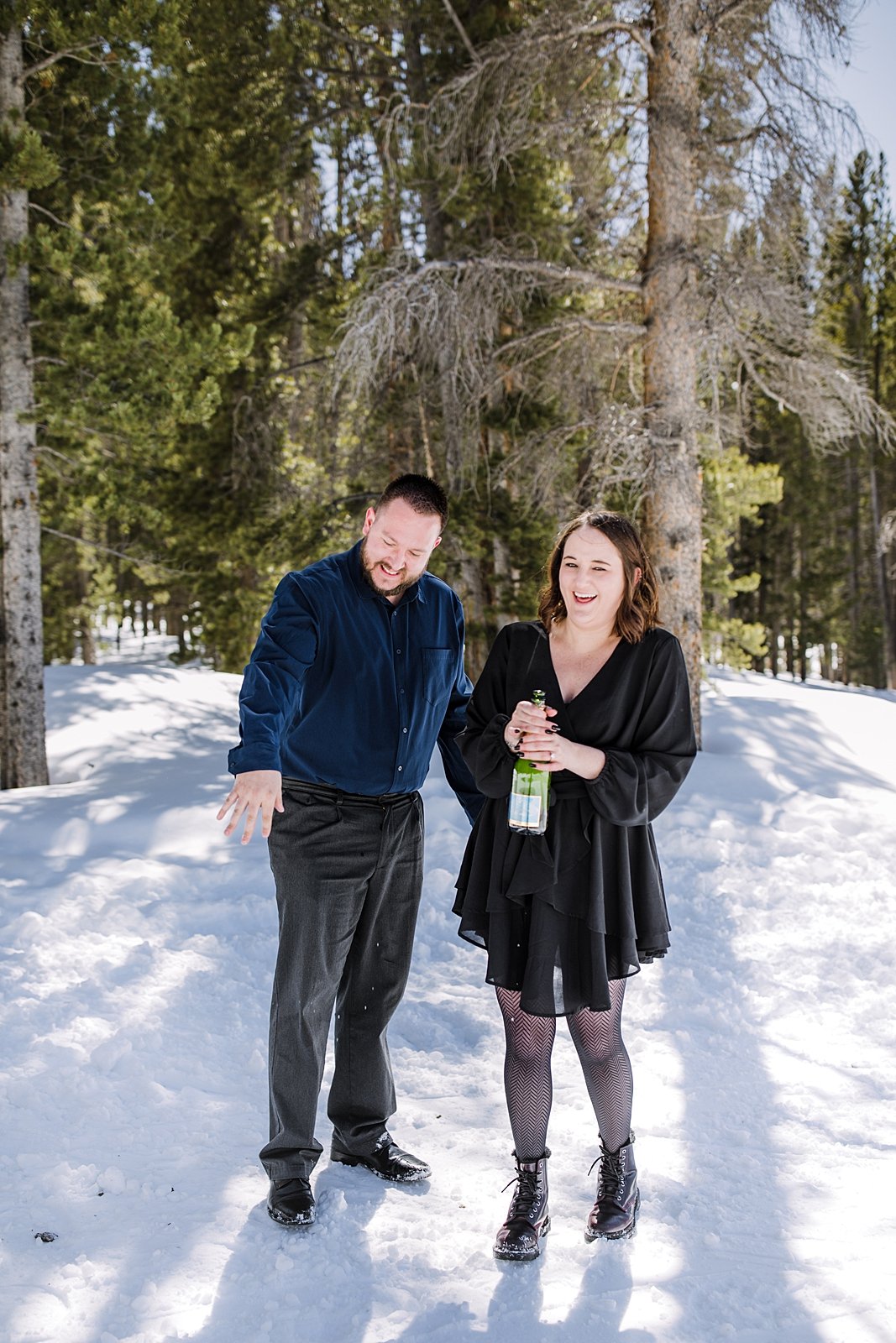 couple popping champagne, popping champagne in the woods, post proposal champagne pop, popping champagne in the mountains, proposal champagne pop, champagne pop in the national forest