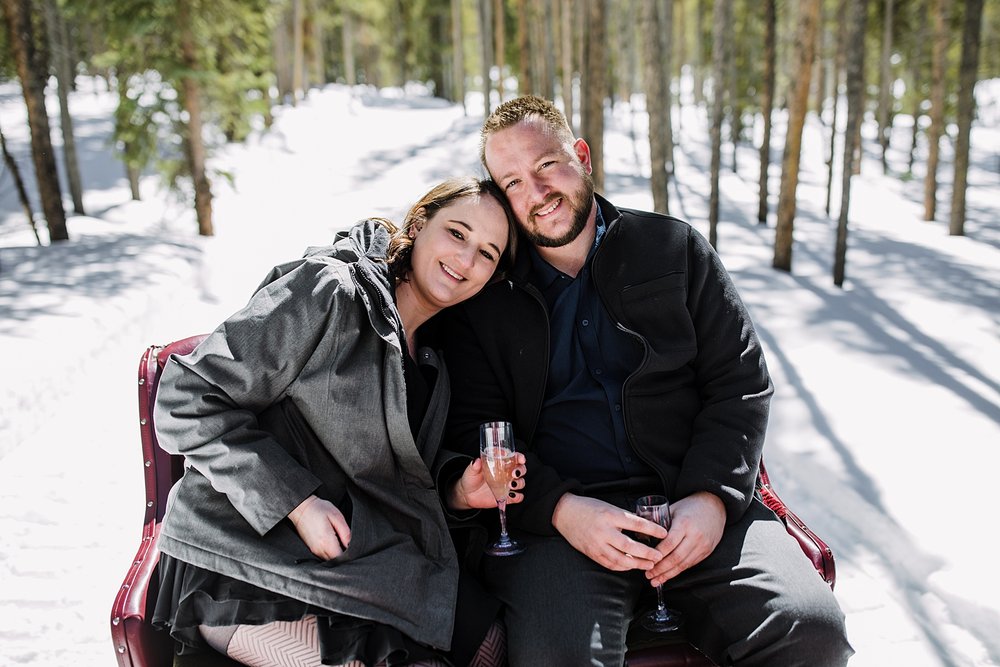 couple cuddling on a sleigh ride, couple riding in a horse drawn sleigh, breckenridge sleigh rides, white river national forest winter activities, golden horseshoe sleigh ride, frisco sleigh ride