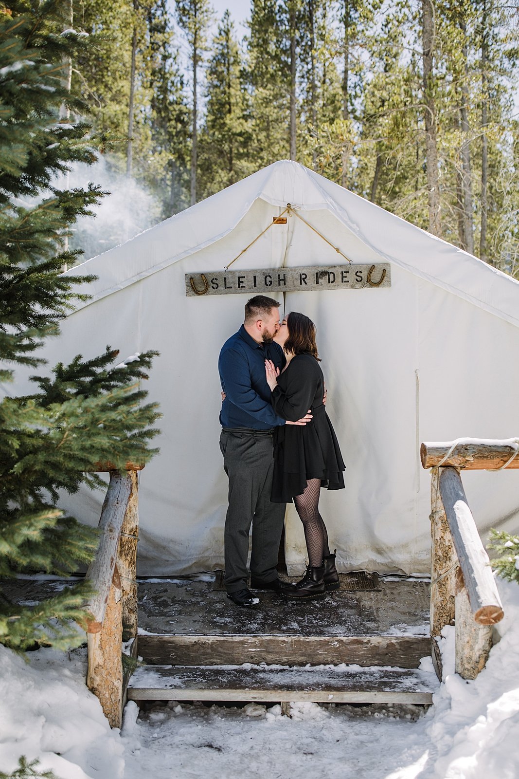 couple kissing in front of canvas tent, winter tent engagements, georgia pass winter proposal, georgia pass winter engagements, alpine engagements, alpine proposal, black engagement dress