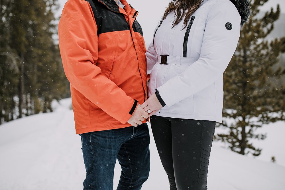couple holding hands, engagement ring in the snow, summit county winter engagement, breckenridge winter engagement, colorado winter engagement, leadville winter engagement, snowy engagement