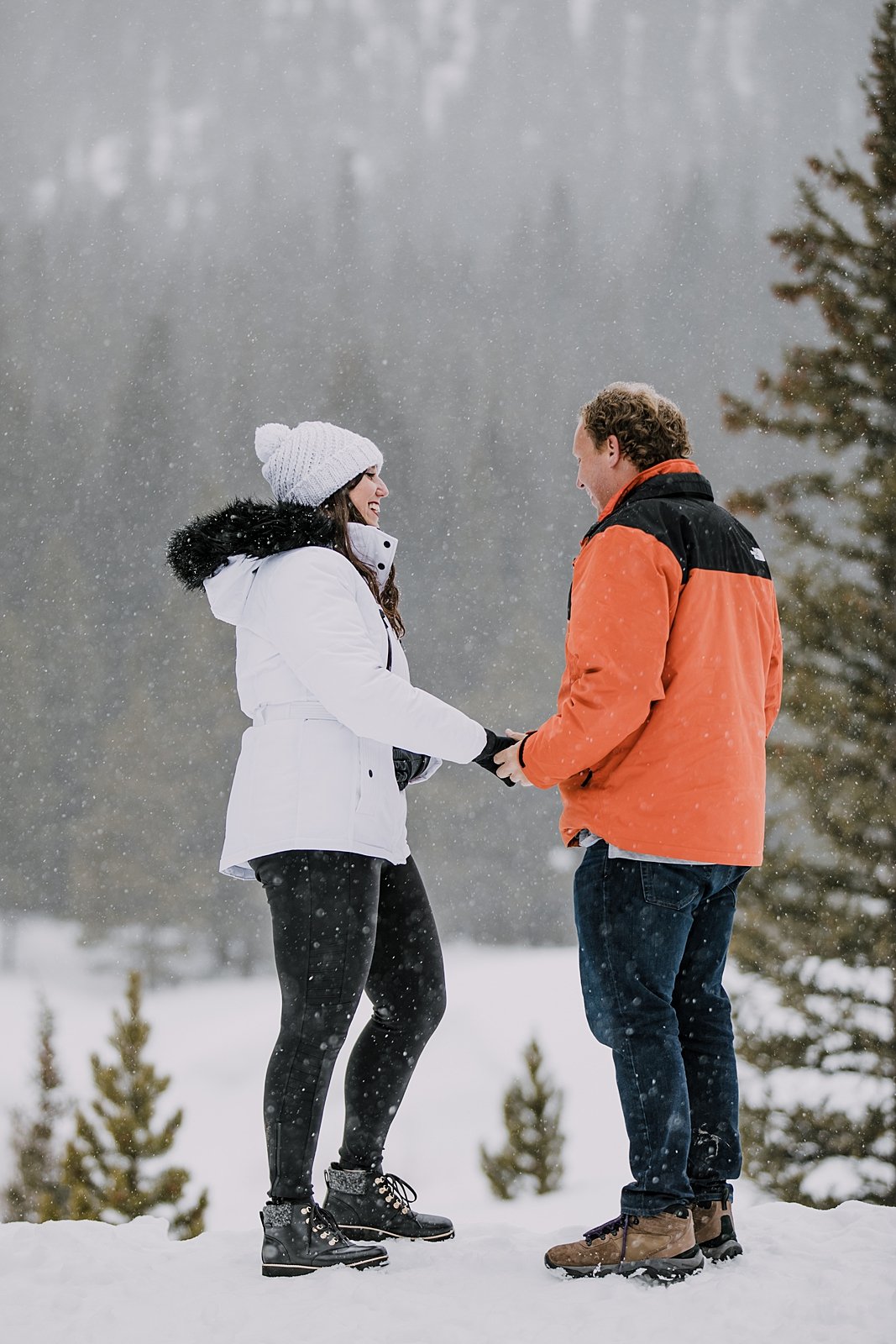 couple holding hands in the snow, man proposing in the snow, mountain proposal, colorado mountain proposal, winter proposal, backcountry proposal, white river national forest proposal