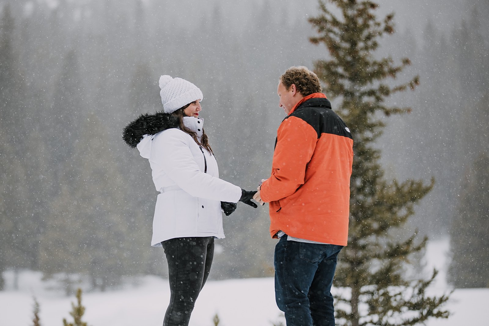 couple holding hands in the snow, man proposing in the snow, mountain proposal, colorado mountain proposal, winter proposal, backcountry proposal, white river national forest proposal