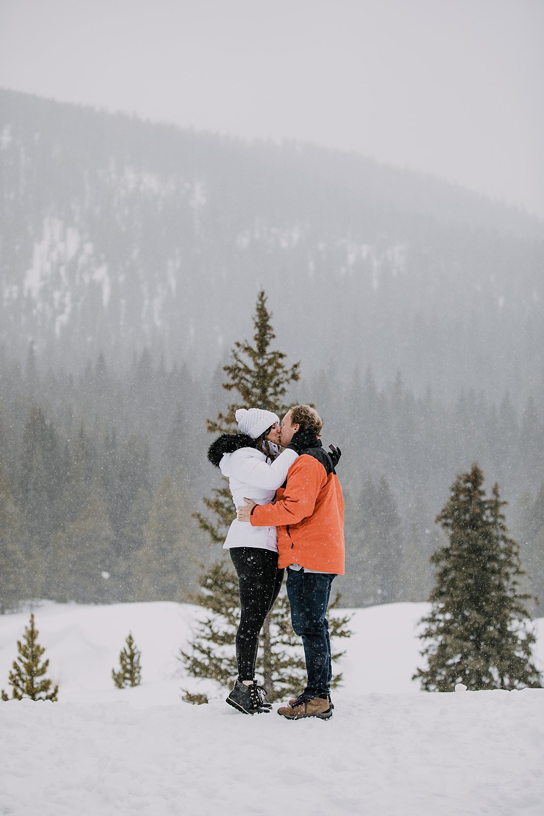 couple kissing after proposal, summit county proposal, summit county winter proposal, colorado winter wedding, snowy breckenridge winter wedding, good times adventures sleigh ride, engagement ring