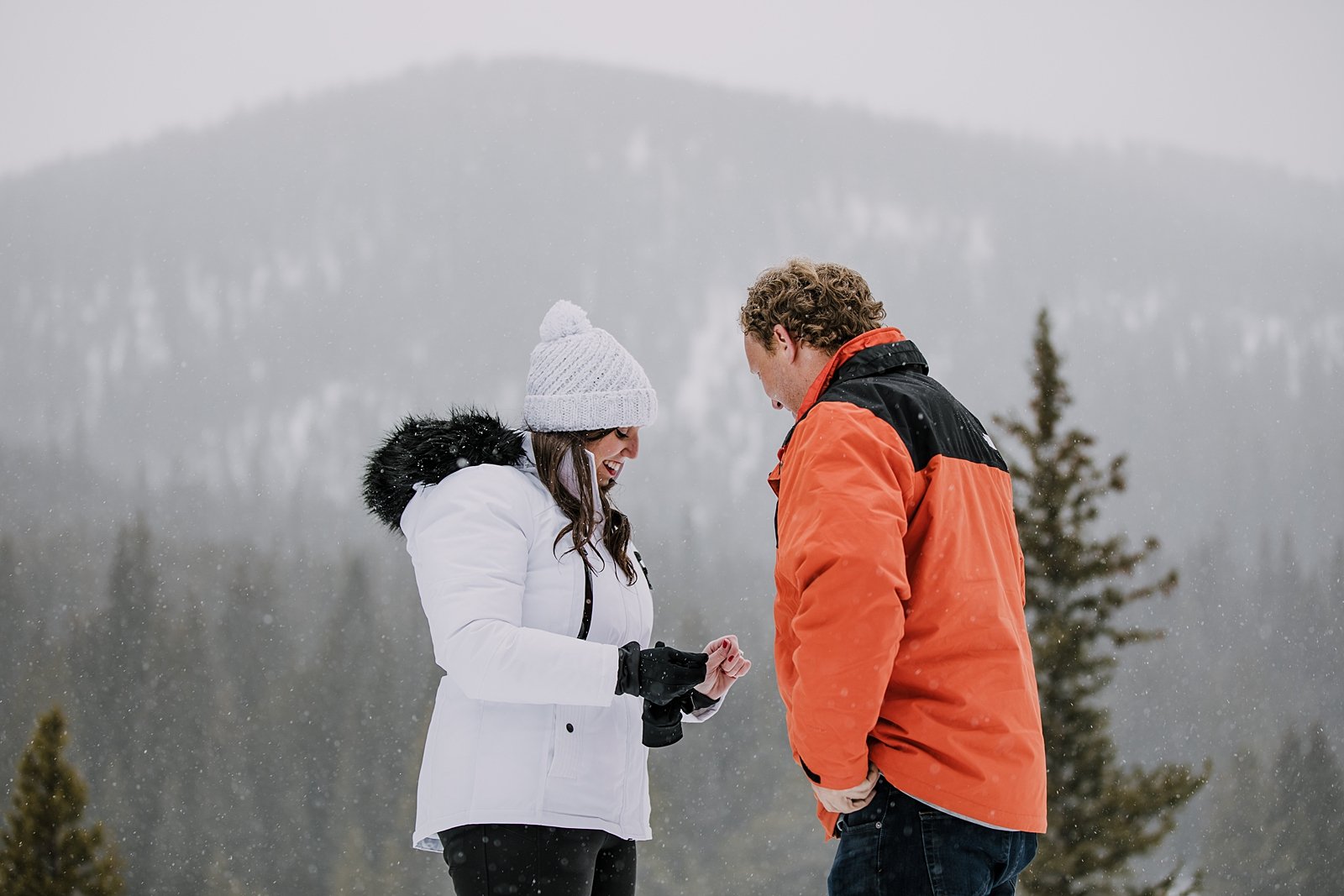 girl looking down at engagement ring, summit county proposal, summit county winter proposal, colorado winter wedding, breckenridge winter wedding, summit county sleigh rides, snowy engagement