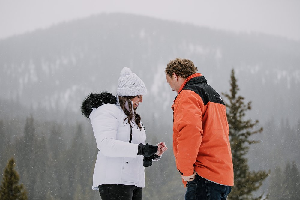 girl looking down at engagement ring, summit county proposal, summit county winter proposal, colorado winter wedding, breckenridge winter wedding, summit county sleigh rides, snowy engagement